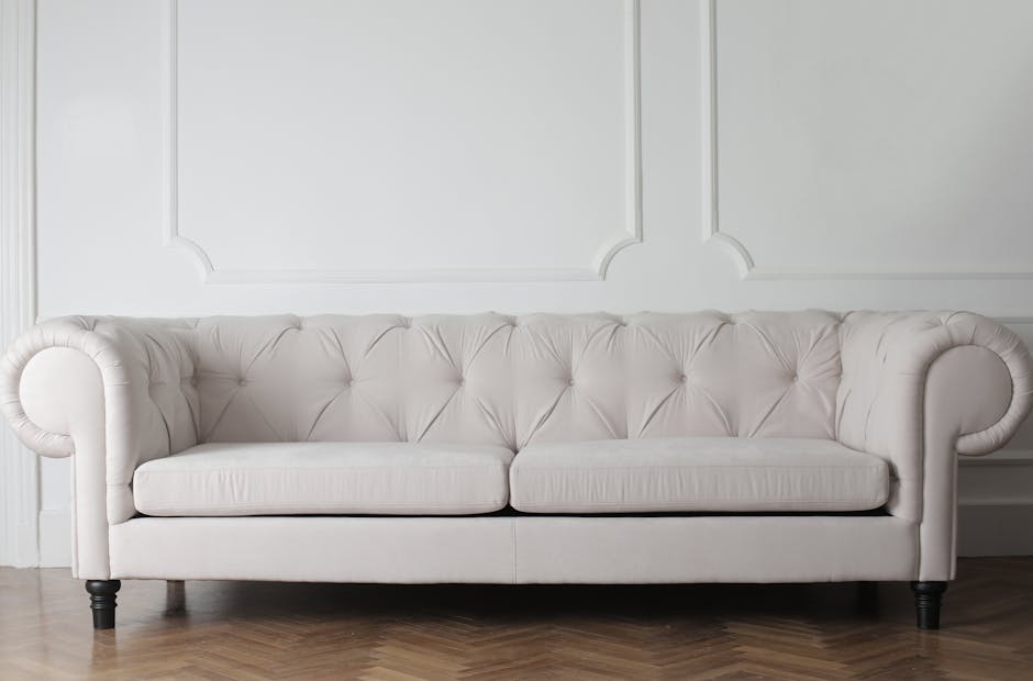 A long, modern bench upholstered in bright blue fabric, situated against a plain white wall in an indoor commercial space. The bench features a smooth, clean surface with no visible dust or stains, in